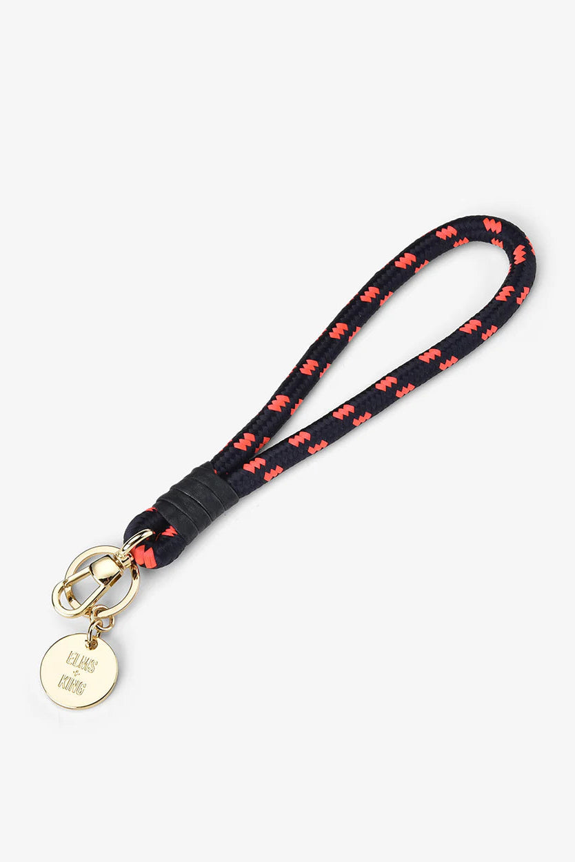 Black lanyard with red butterfly pattern and gold tag on a white background
