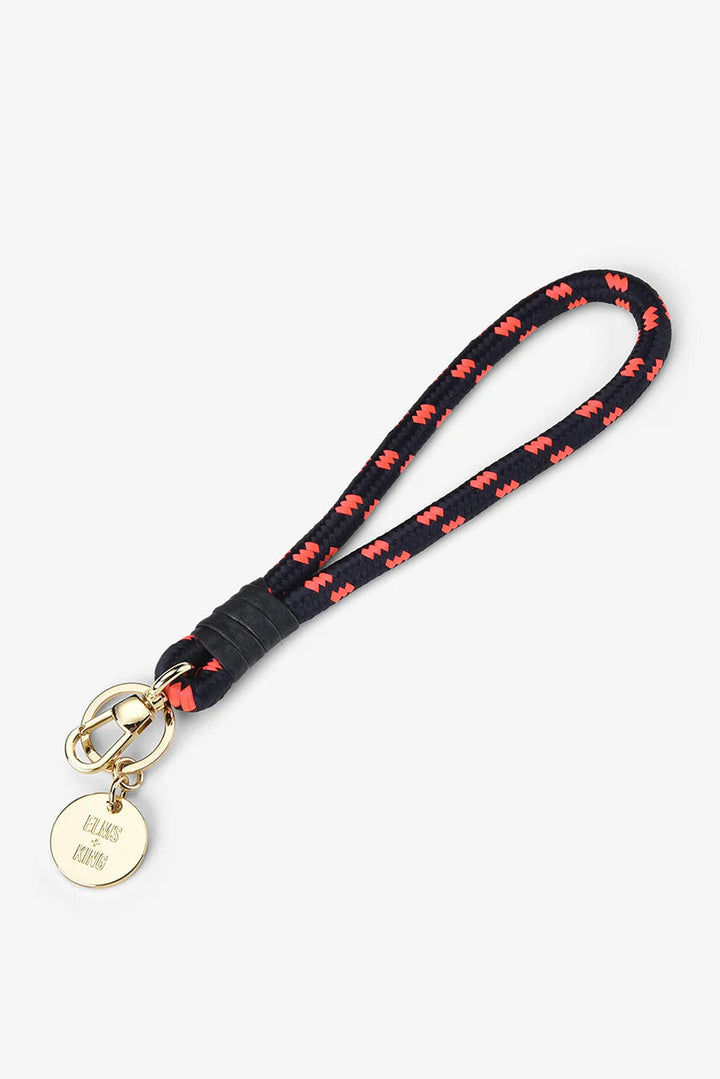 Black lanyard with red butterfly pattern and gold tag on a white background
