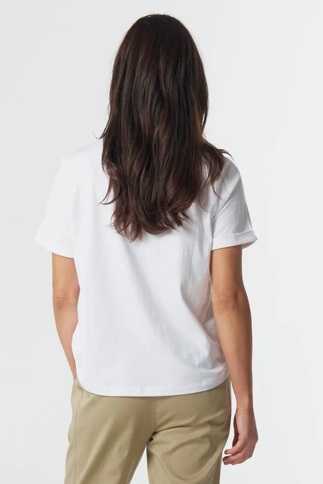 Person wearing a white t-shirt and beige pants on a white background