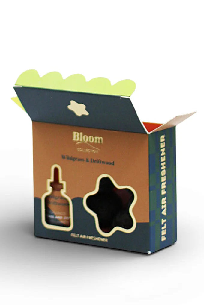Open box packaging with a star-shaped air freshener and dropper, branded 'Bloom'.