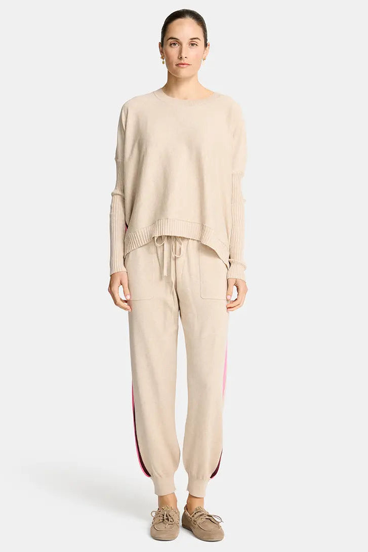 Woman wearing a beige outfit with a plain background