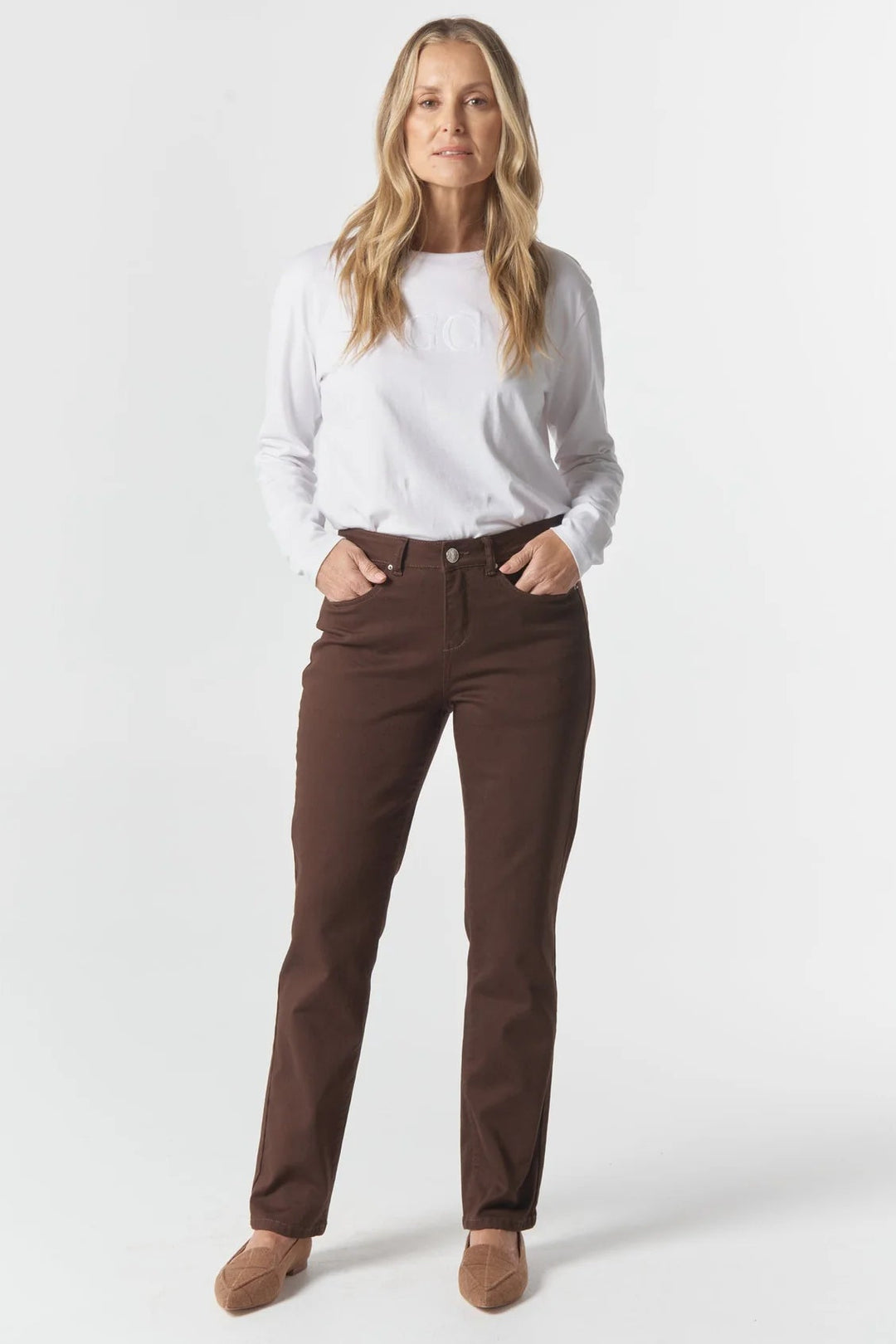 Woman wearing a white shirt and brown pants on a white background