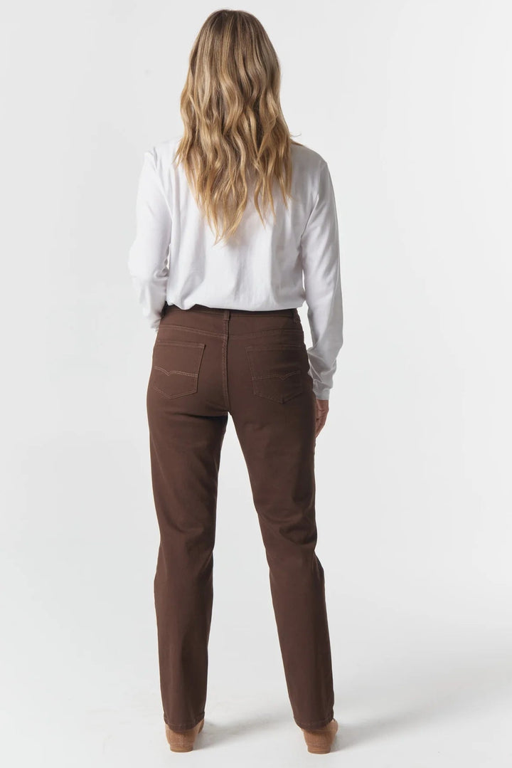 Person wearing brown pants and a white shirt on a white background