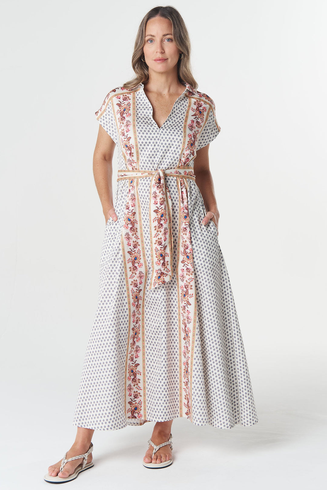 Woman wearing a white dress with floral patterns on a white background