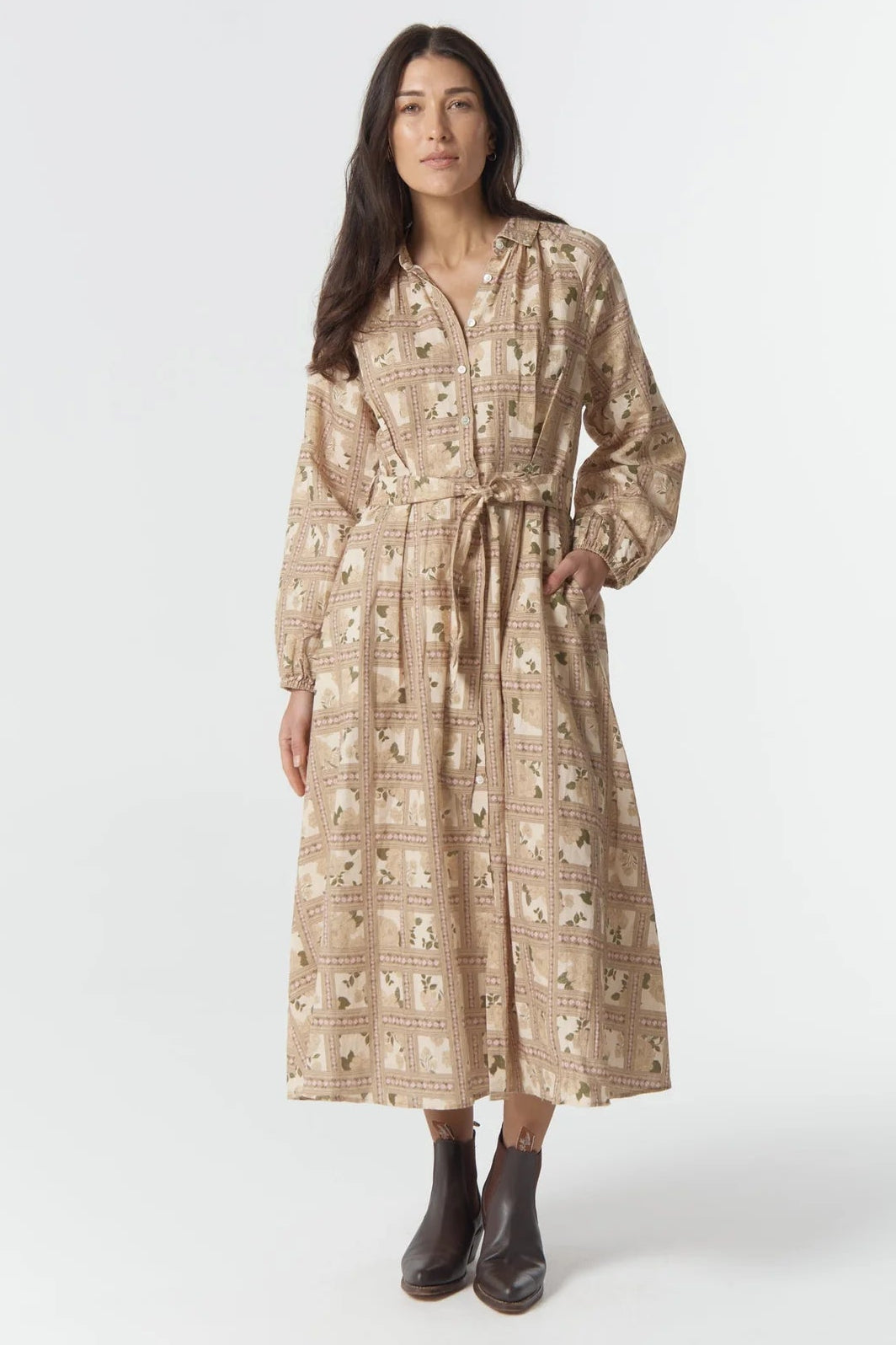 Woman wearing a patterned dress on a white background