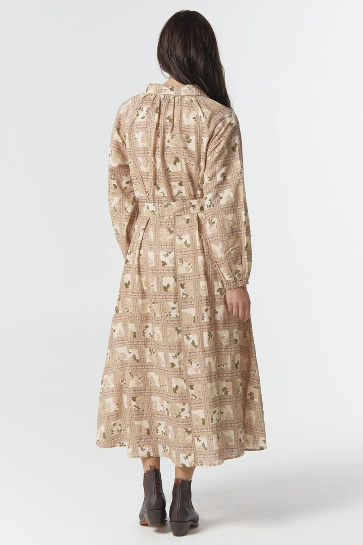 Woman wearing a patterned dress on a white background