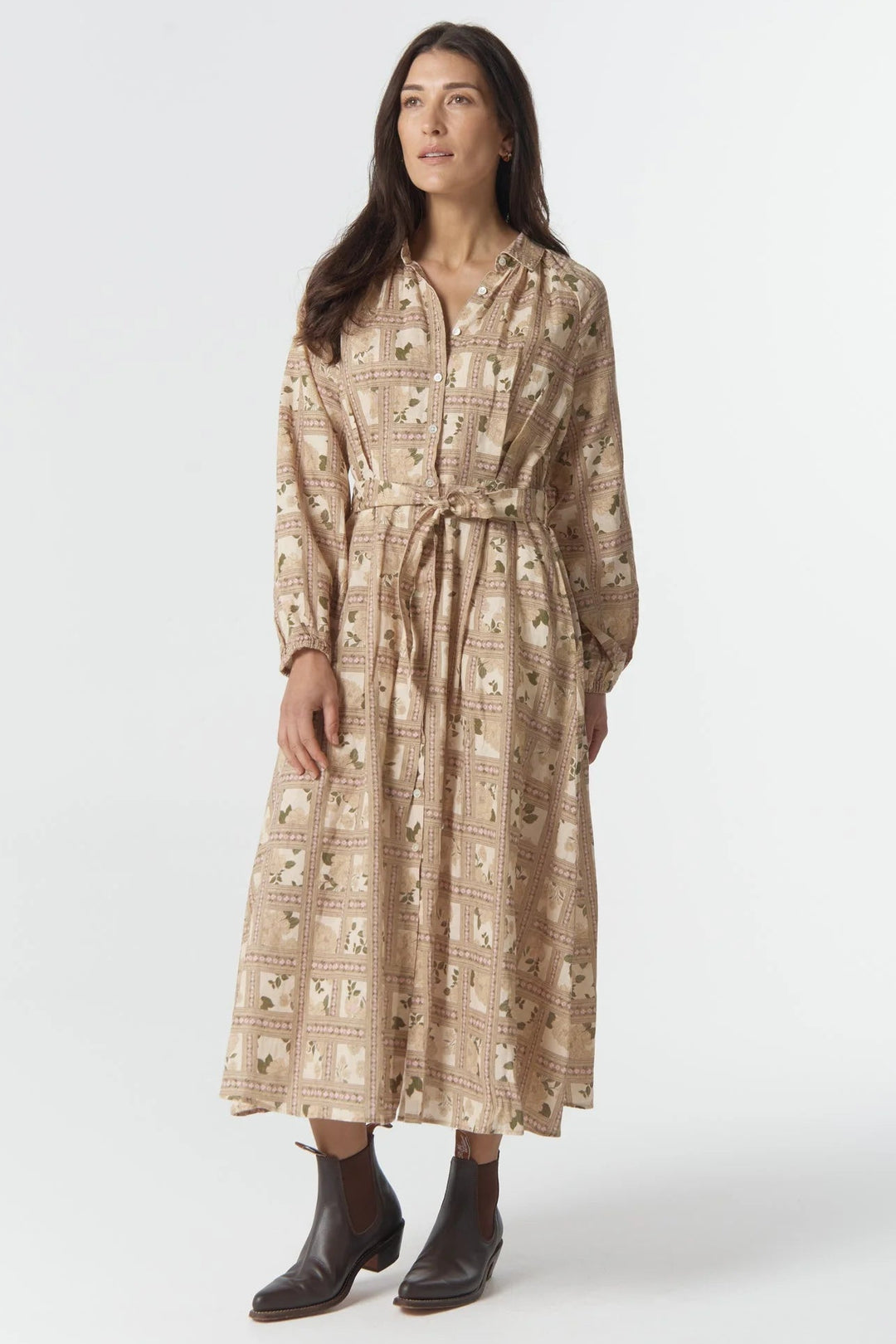 Woman wearing a patterned dress on a white background