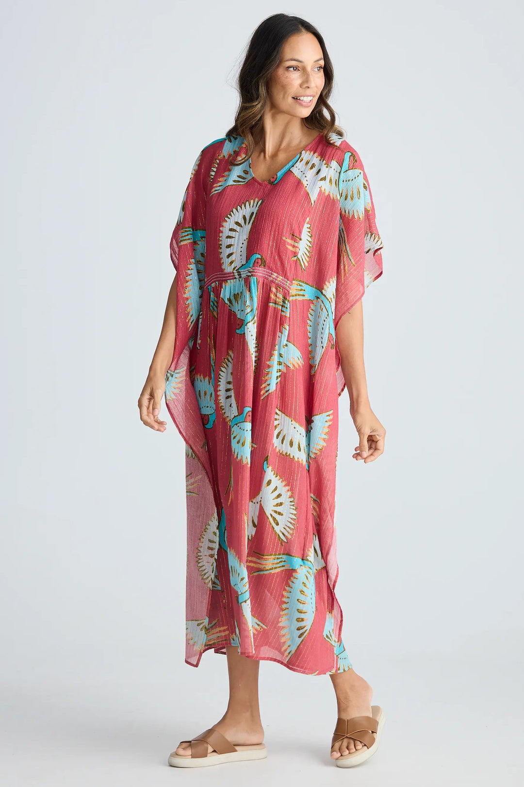 Woman wearing a pink floral dress on a white background. Holiday Trading Lorrini Kaftan Red Macaw