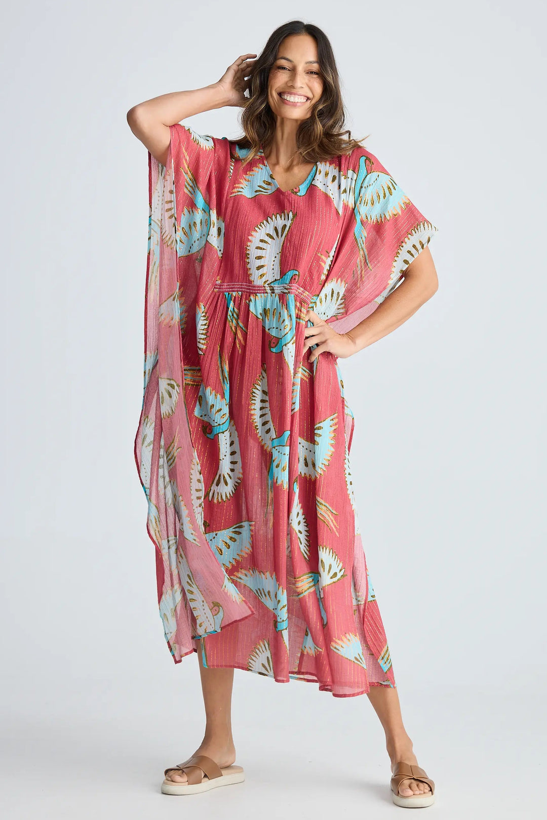Woman wearing a pink floral dress on a white background. Holiday Trading Lorrini Kaftan Red Macaw