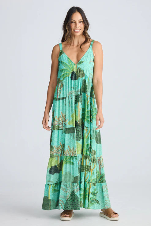 Woman wearing a green patterned dress on a white background. Holiday Trading Evianna Dress Rainforest Print