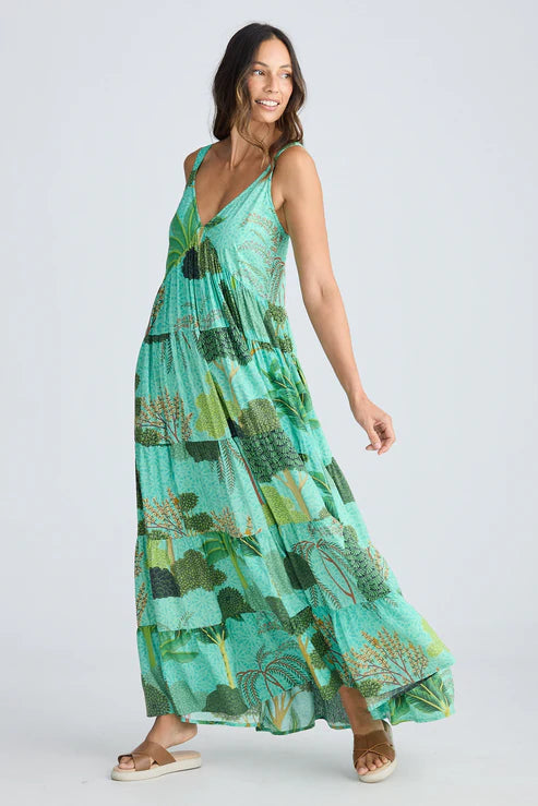 Woman wearing a green patterned dress on a white background.  Holiday Trading Evianna Dress Rainforest Print