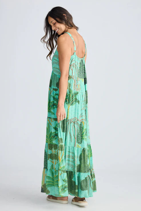 Woman wearing a green patterned dress on a white background.  Holiday Trading Evianna Dress Rainforest Print