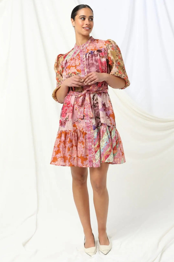 Woman wearing a colorful floral dress on a white background