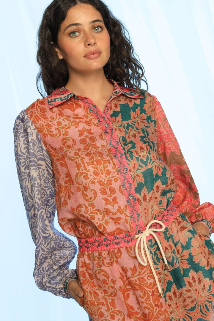 Woman wearing a colorful patterned outfit on a light blue background
