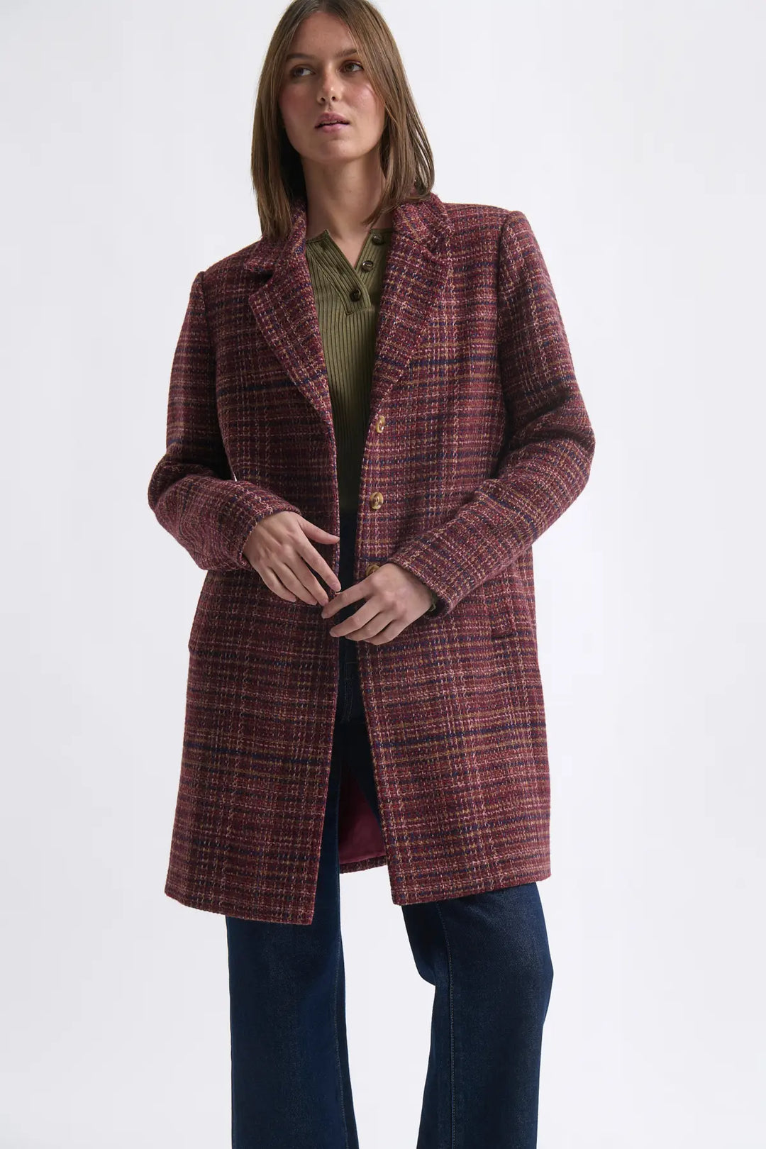 Woman wearing a plaid coat on a white background