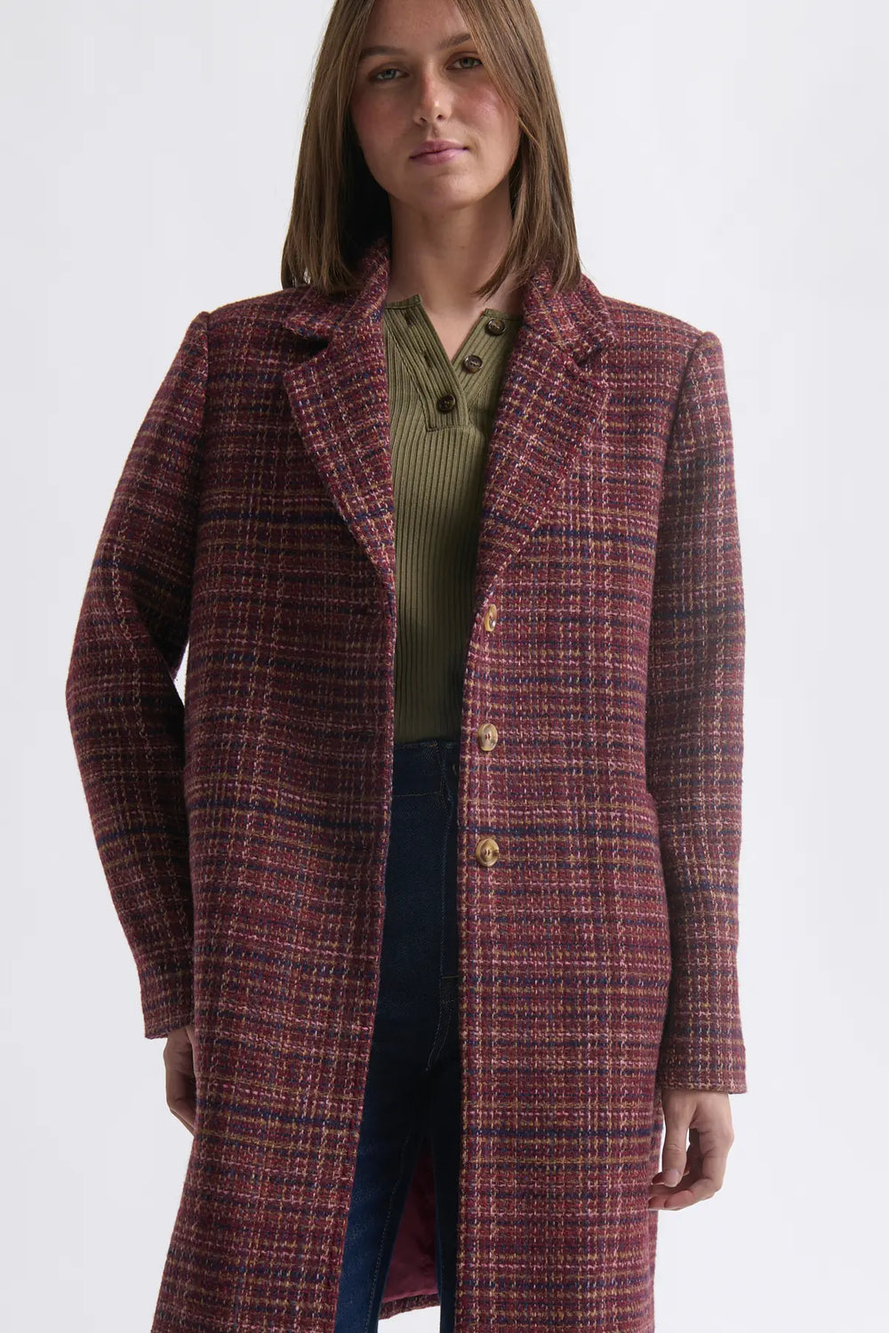 Woman wearing a plaid coat on a white background