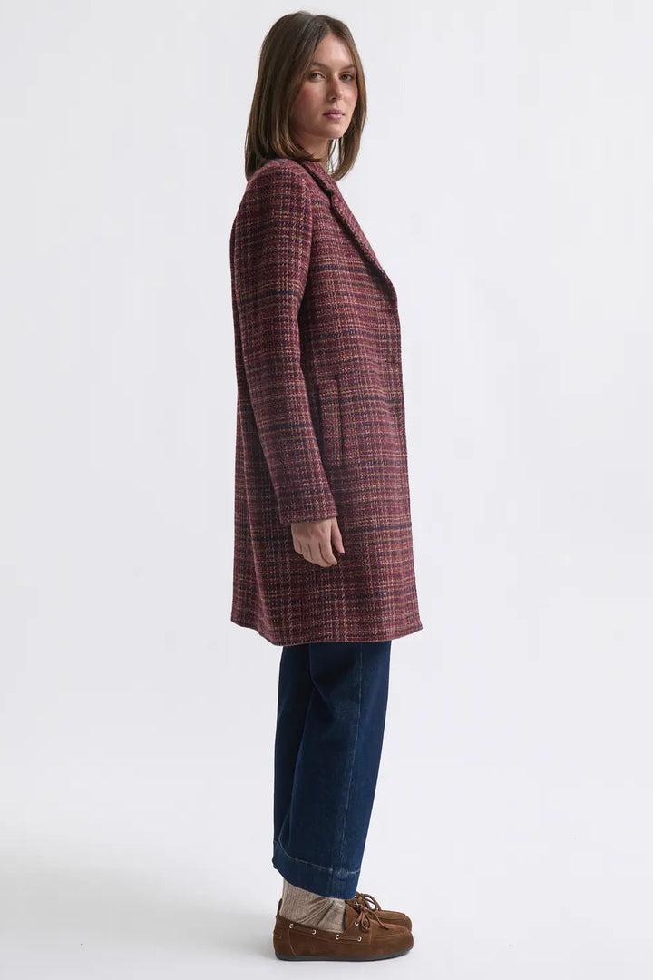 Woman wearing a plaid coat on a white background