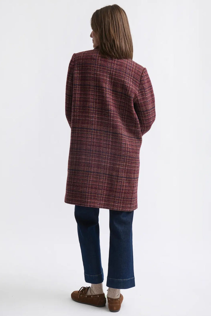 Person wearing a plaid coat on a white background