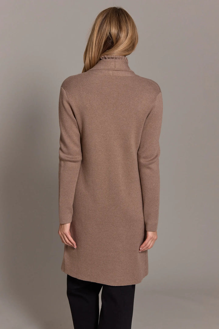 Woman wearing a brown coat against a plain background