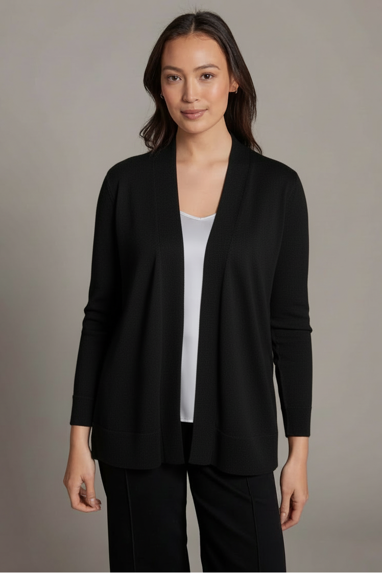 Woman wearing a black blazer over a white top on a gray background