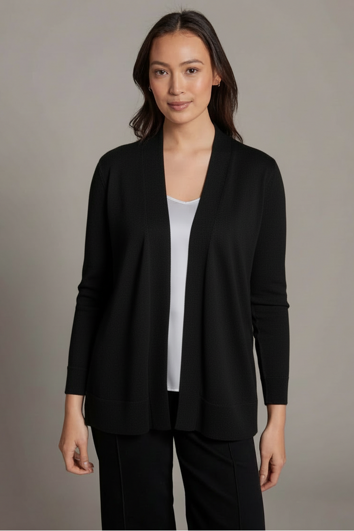 Woman wearing a black blazer over a white top on a gray background