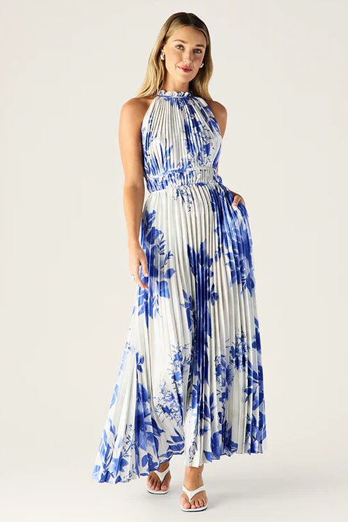 Woman wearing a blue and white tie-dye dress on a white background