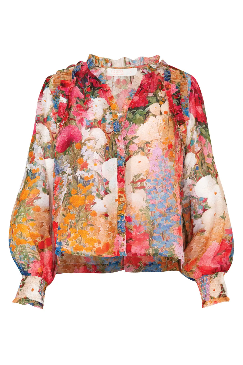A long-sleeve blouse with a vibrant, multicolor floral and abstract print, featuring a ruffled collar and gathered cuffs, shown against a plain white background.
