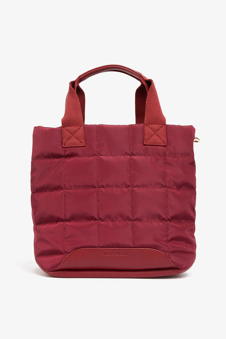 Burgundy quilted tote bag on a white background