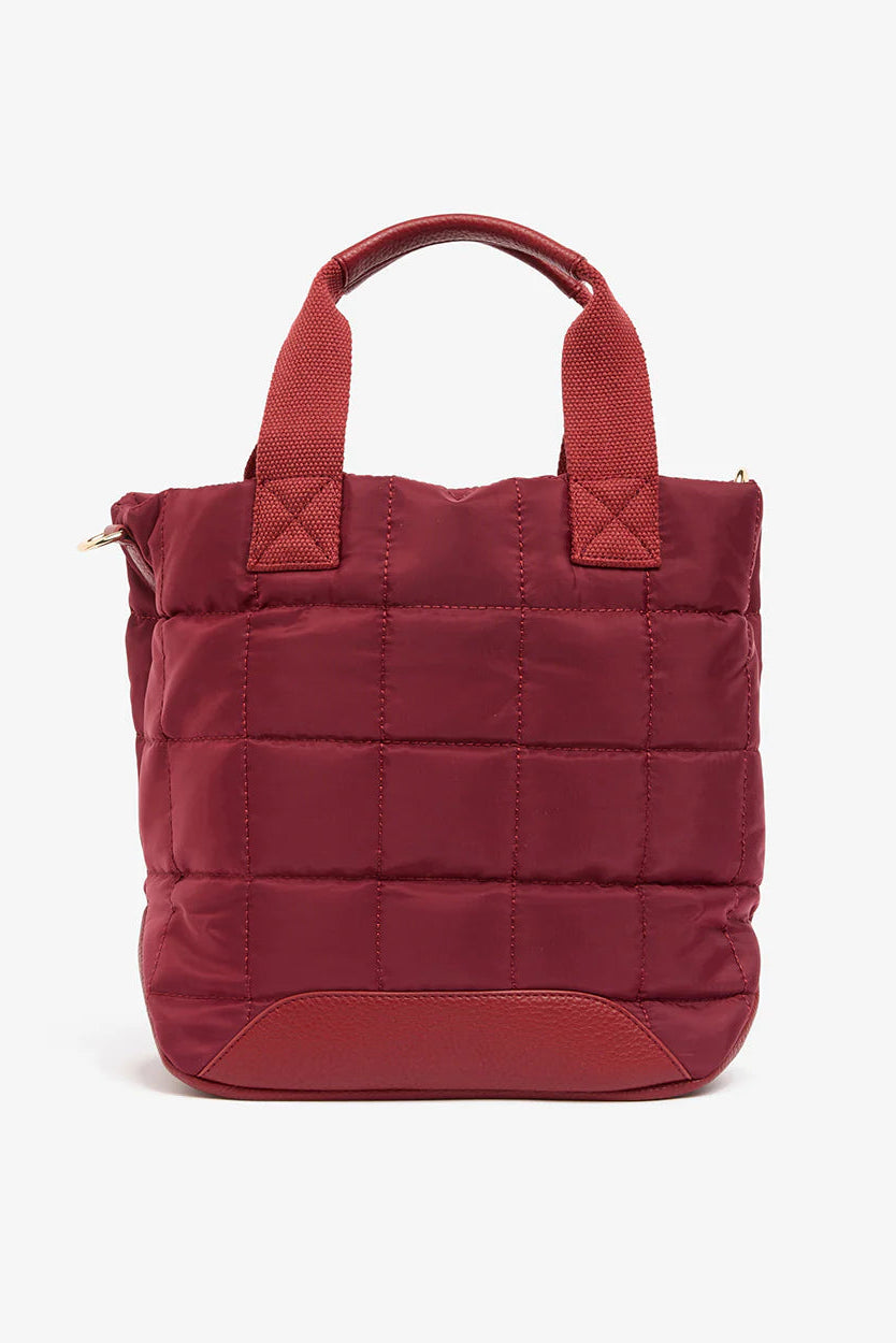 Burgundy quilted tote bag on a white background