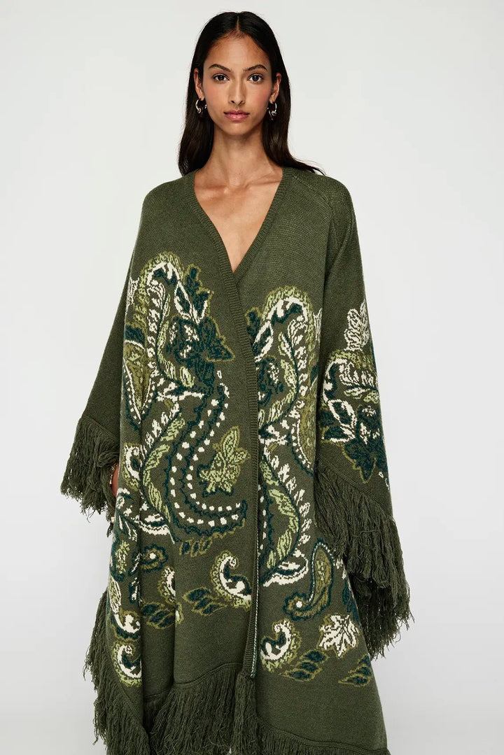 Woman wearing a green patterned cardigan on a white background