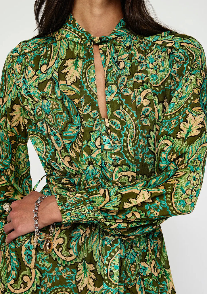 Green and gold patterned dress with a close-up on a white background