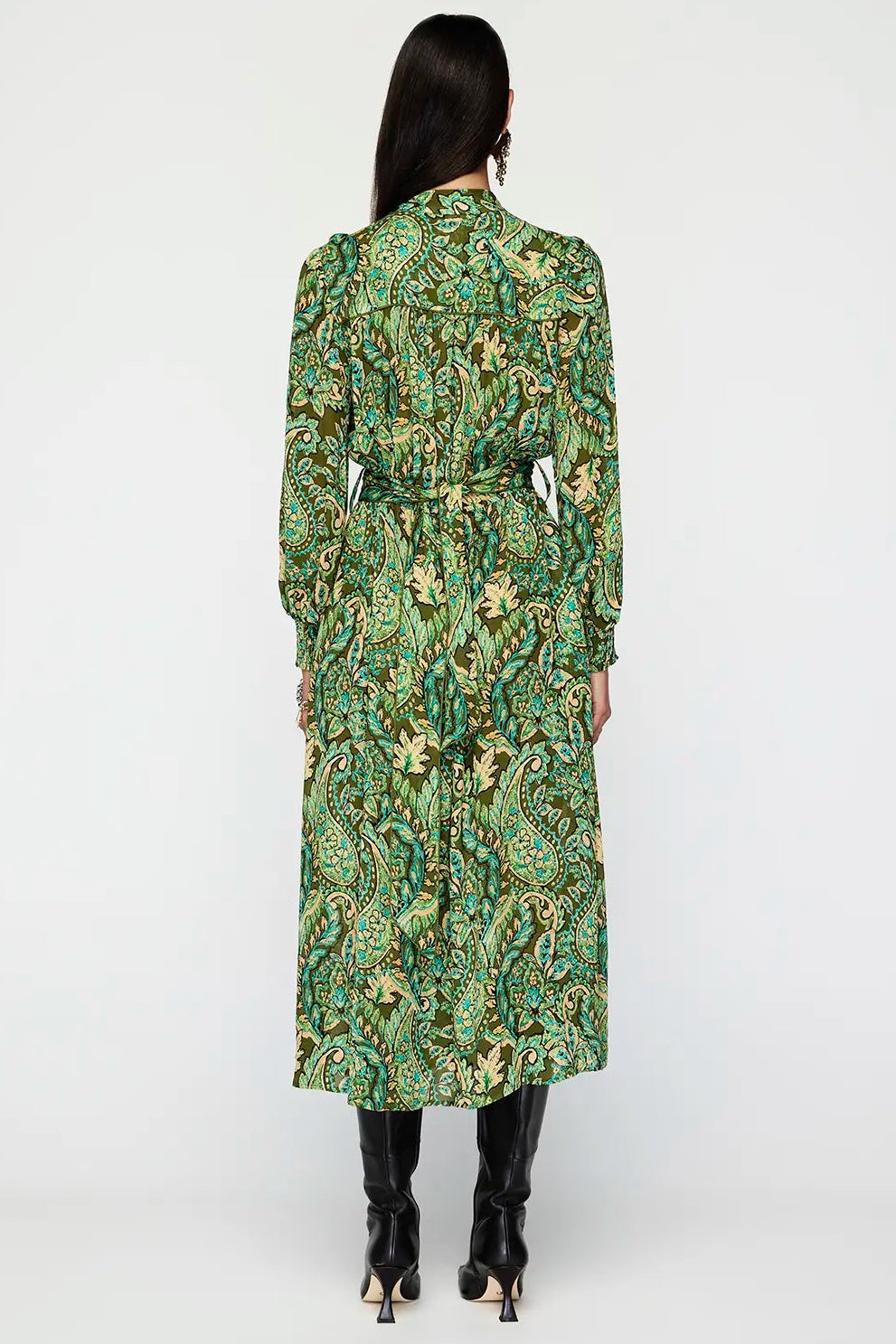 Woman wearing a green floral patterned dress on a white background