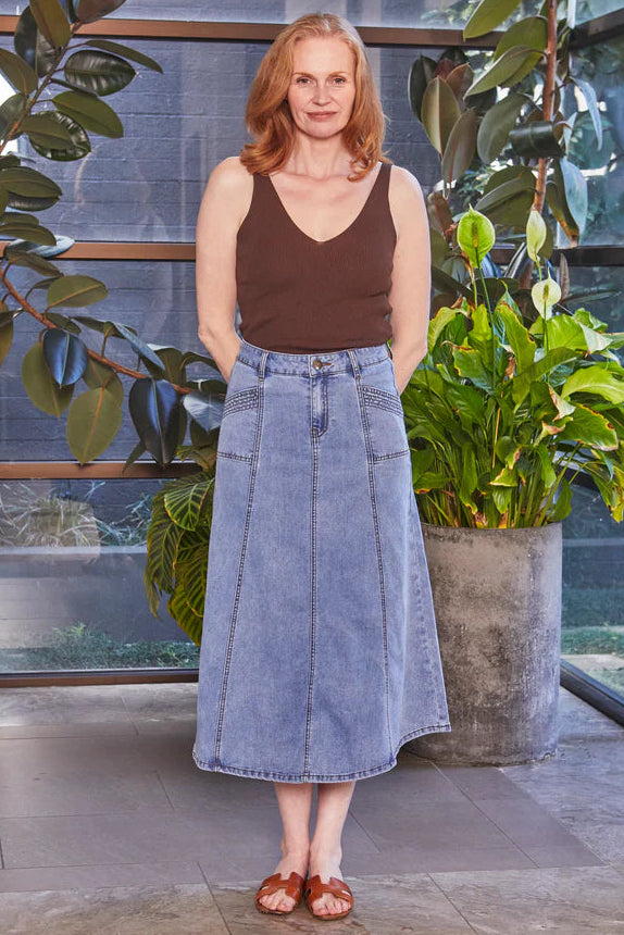 Woman standing in a modern indoor setting with plants