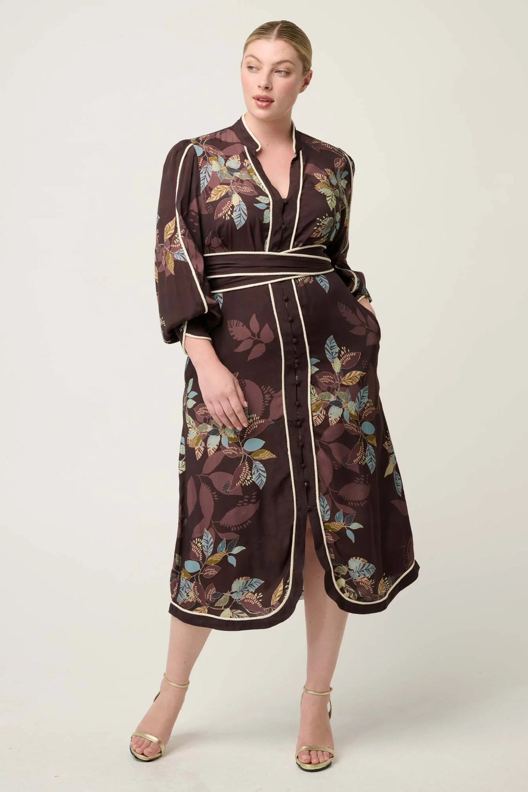 Woman wearing a floral patterned robe on a white background