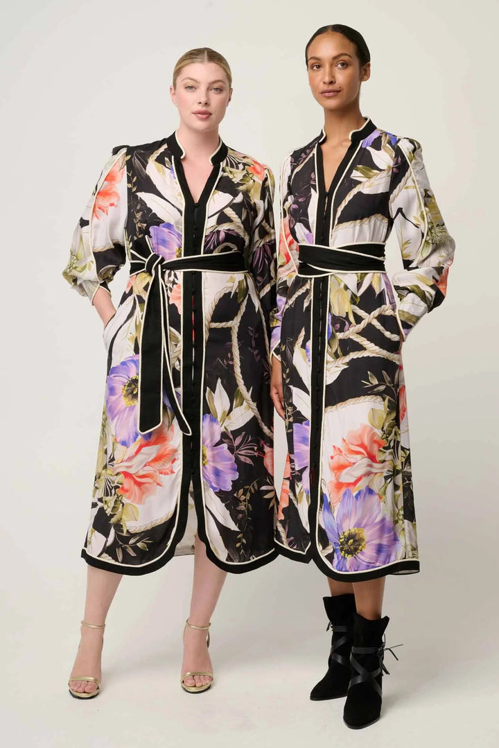Two models wearing floral-patterned dresses on a white background