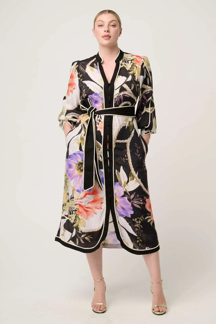 Woman wearing a floral kimono-style dress on a white background