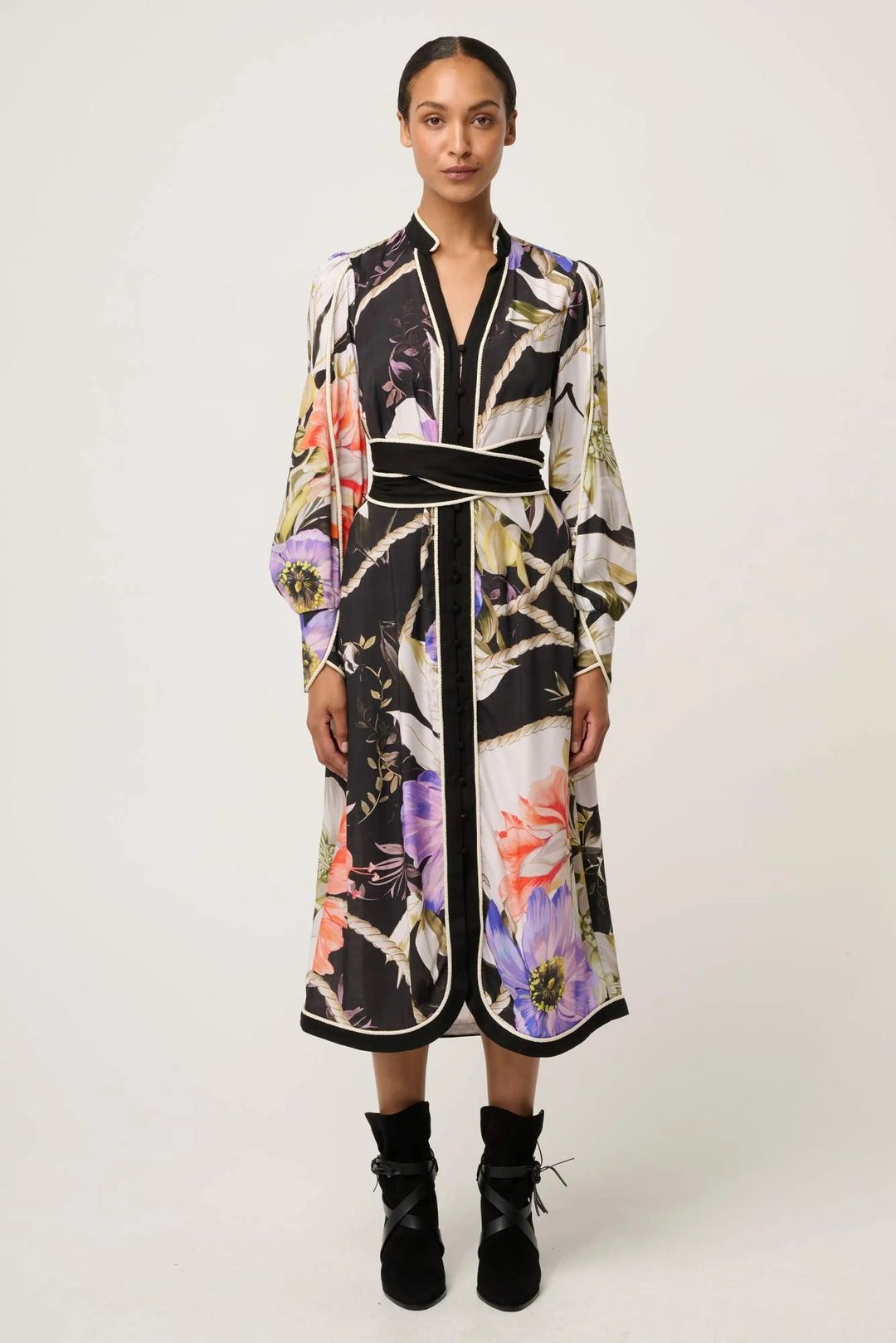 Woman wearing a floral patterned dress on a white background