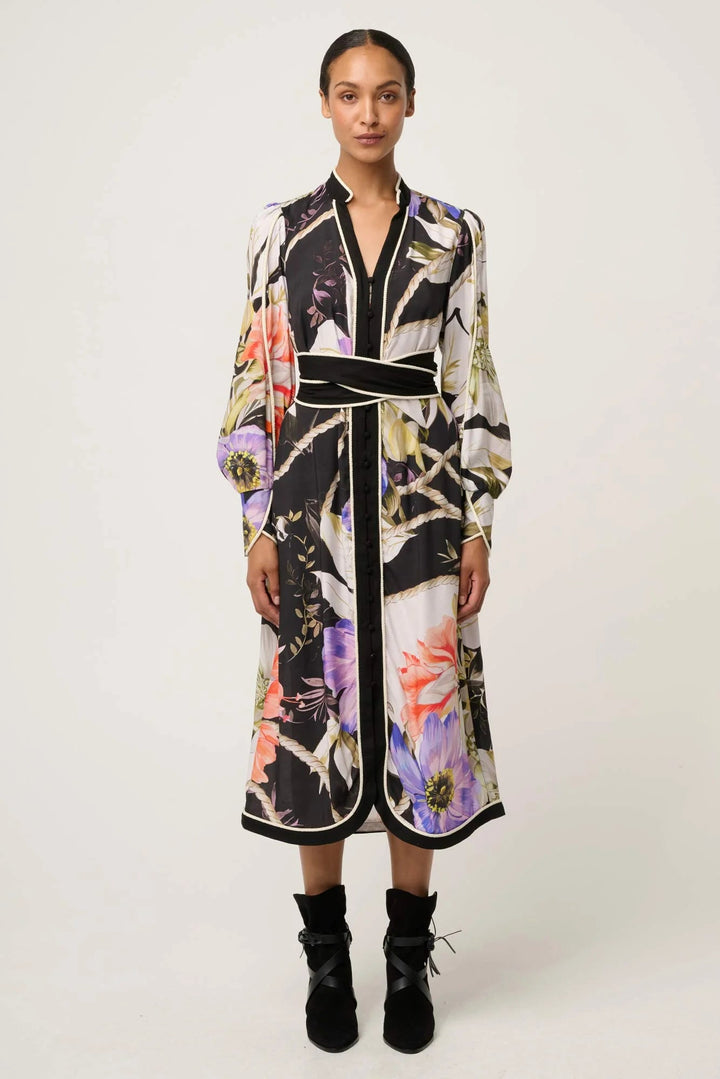 Woman wearing a floral patterned dress on a white background