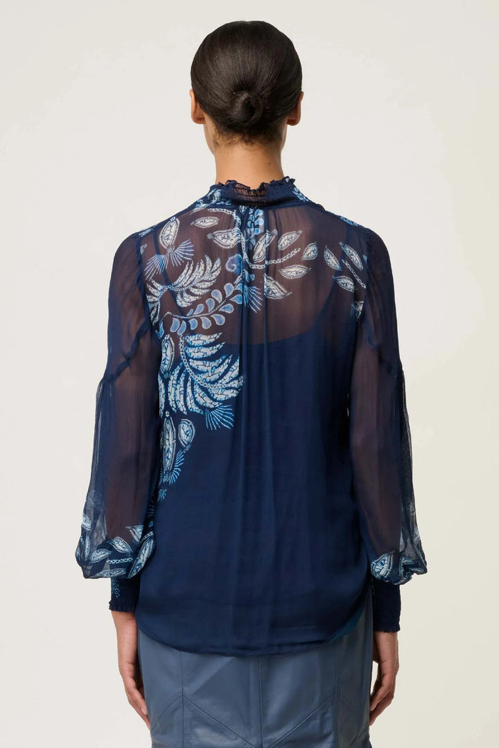 Navy blue blouse with floral embroidery on a plain background