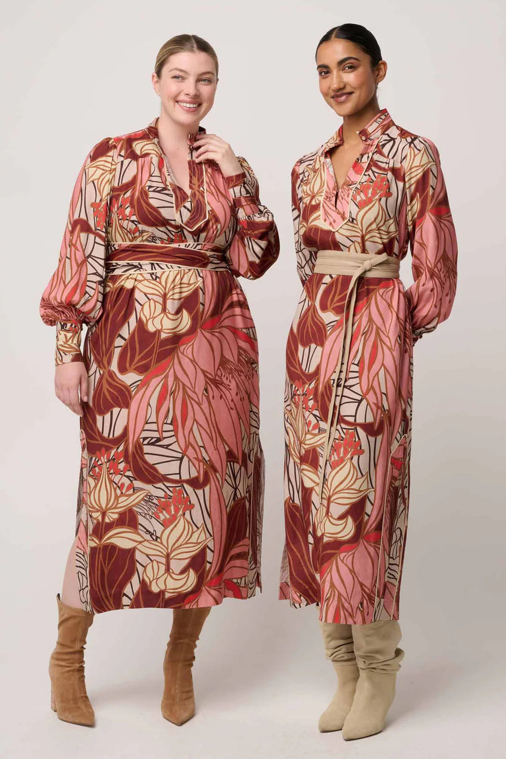 Two women wearing patterned dresses and beige boots on a white background