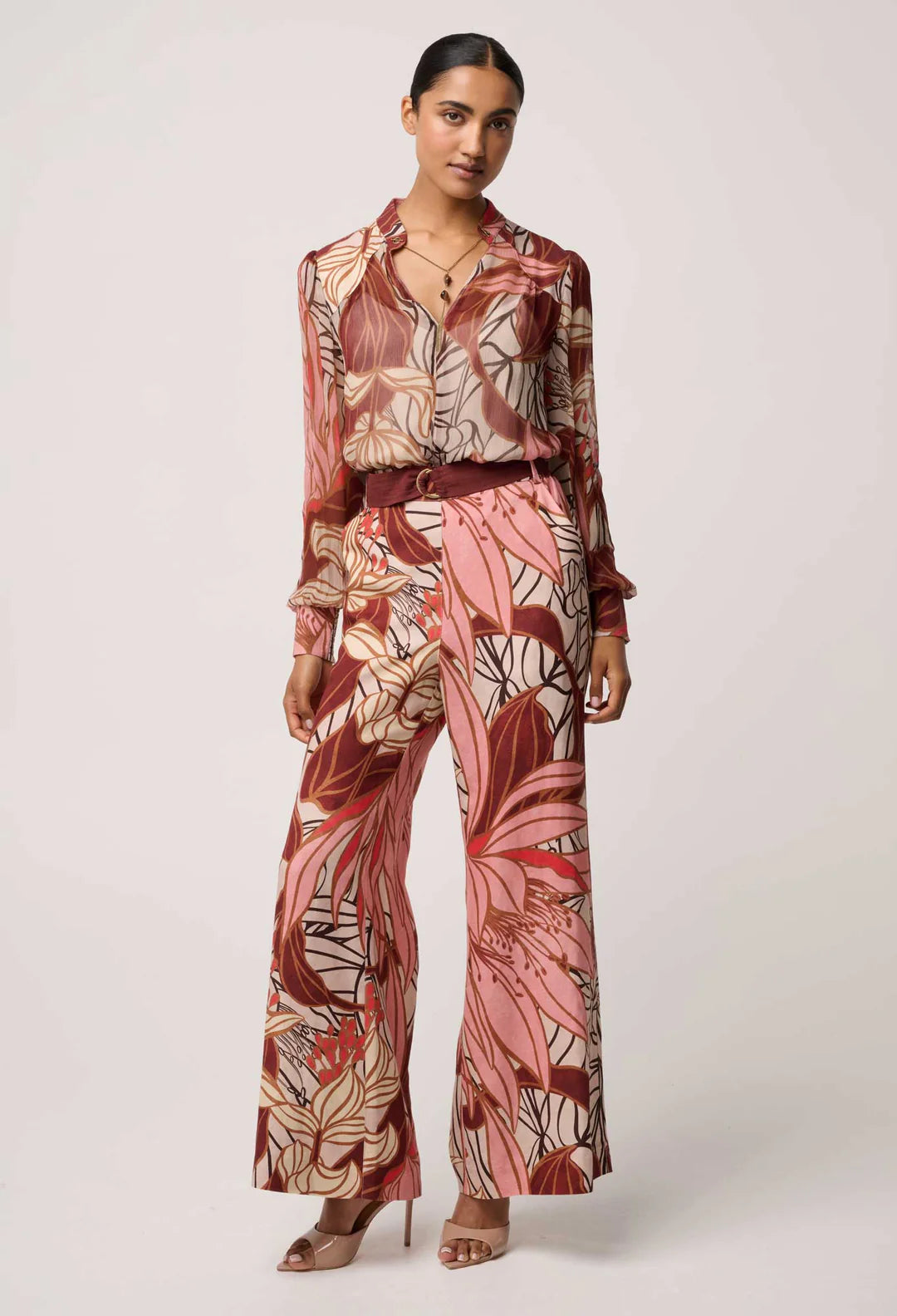 Woman wearing a patterned outfit with a white background