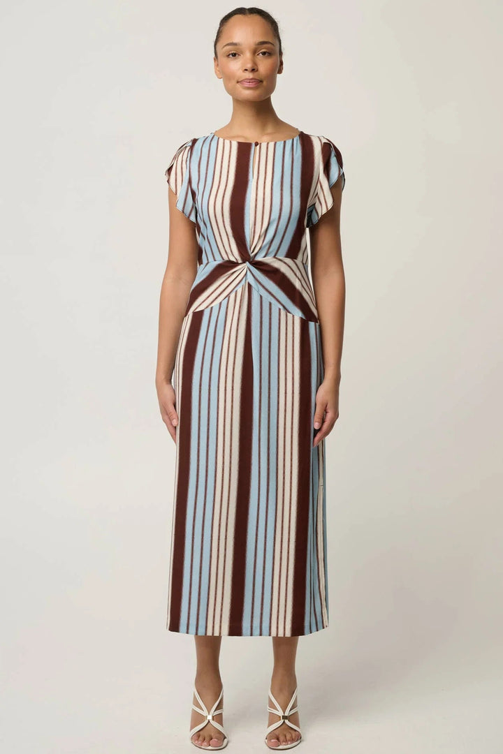 A woman modeling a midi dress with vertical stripes in brown, cream, and light blue, featuring cap sleeves and a twisted waist detail, set against a plain light gray background.