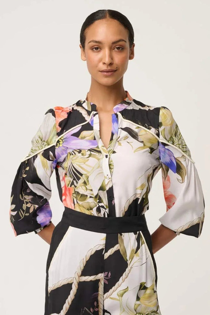 Woman wearing a floral shirt with a white background