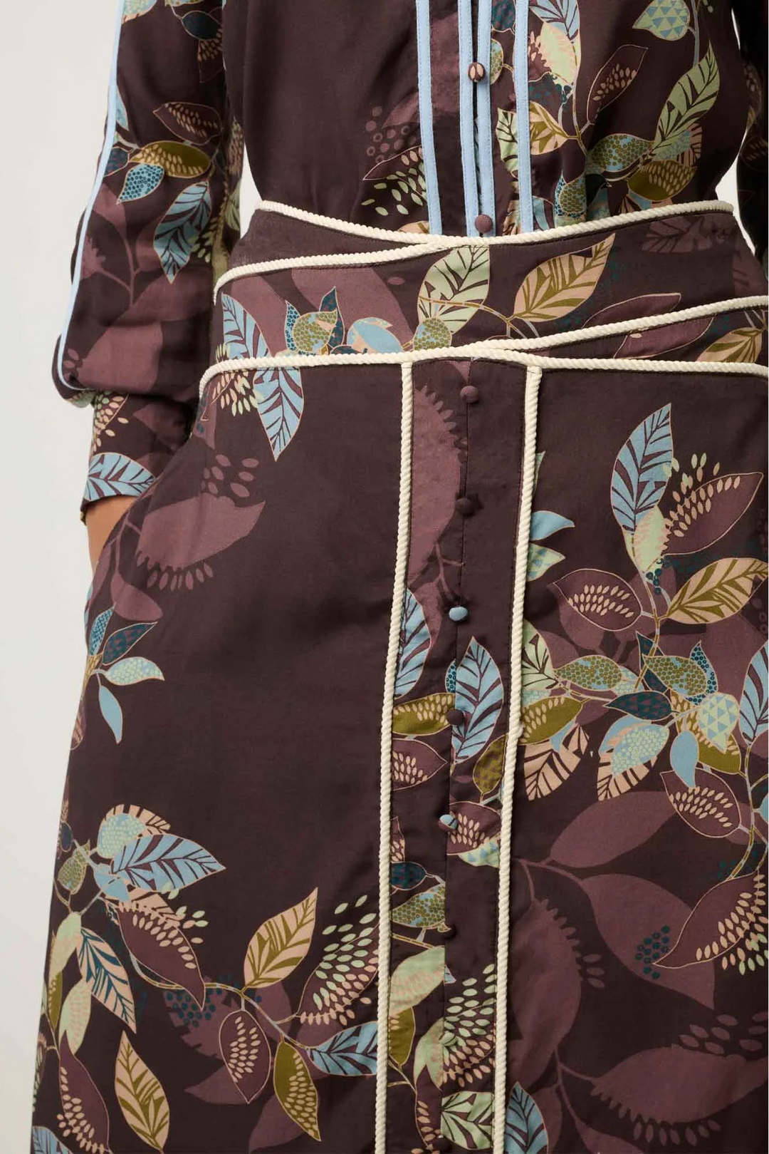 Floral patterned skirt and top on a plain background