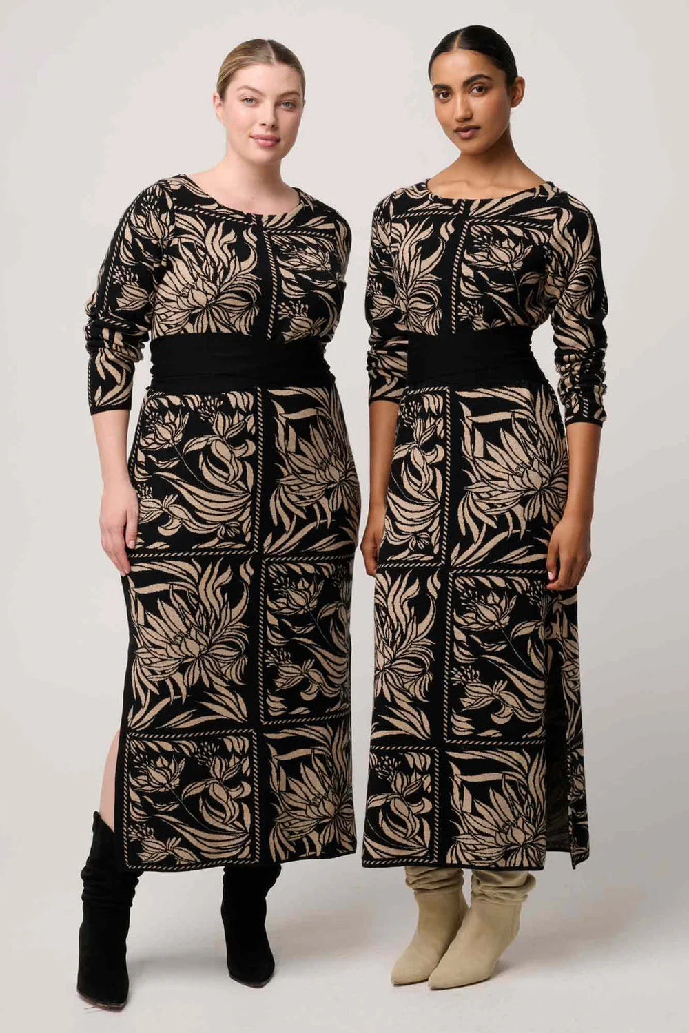 Two models wearing long, patterned dresses on a plain background