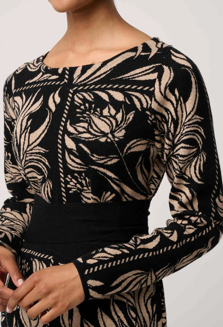 Black and beige patterned long-sleeve top on a plain background