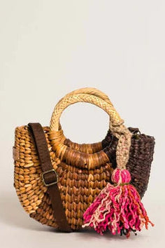 Woven handbag with a handle and pink tassel on a light beige background. Orange Inca Fiesta Mini Classic Browns