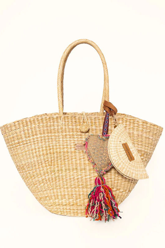 Woven straw bag with colorful tassel on a white background. Orange Inca Playa Tote Natural