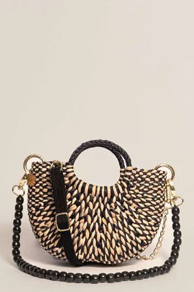 Woven handbag with chain detail on a beige background. Orange Inca The New Mini Fiesta Bag Marbled Black