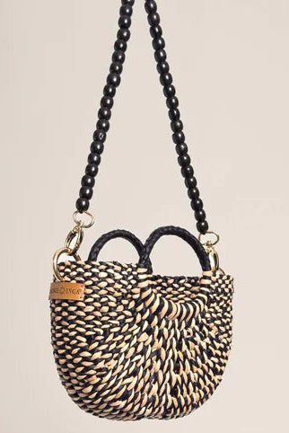 Woven handbag with a chain strap on a beige background. Orange Inca The New Mini Fiesta Bag Marbled Black